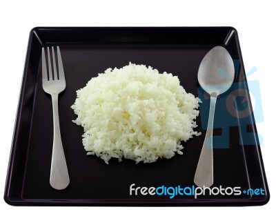 Rice In Black Plate Stock Photo