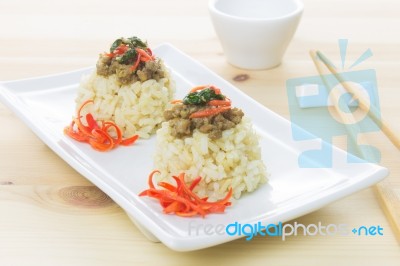 Rice Topped With Stir-fried Pork And Basil And Chopsticks And Small Cup Stock Photo