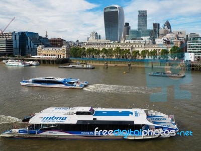 River Buses Cruising Along The River Thames Stock Photo