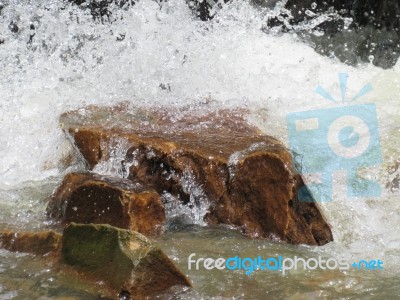 River Water Crushing Against Rock Outdoors Stock Photo