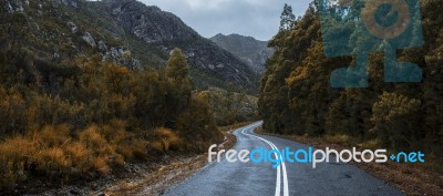 Road And Mountains In The Tasmanian Countryside Stock Photo