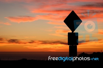 Road Sign Silhouette And Colorful Sunset Stock Photo