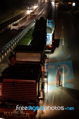 Road Works, Removal Of Old Asphalt Pavement At Night Stock Photo