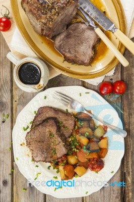 Roast Beef Joint With Roast Vegetables Stock Photo