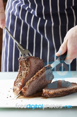 Roast Meat Is Being Carved Stock Photo