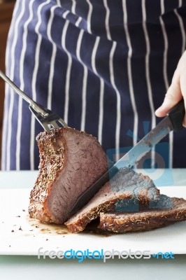 Roast Meat Is Being Carved Stock Photo