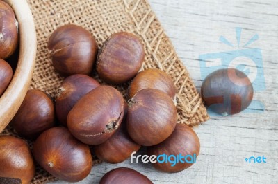 Roasted Chestnuts On Wooden Stock Photo