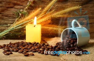 Roasted Coffee Beans And Candle Light Stock Photo