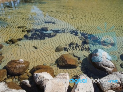 Rock In Clear Lake Water Stock Photo