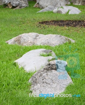 Rock On Grass Field From Public Park Stock Photo