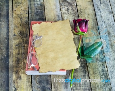 Rose,glasses On Notebook On Wooden Background Stock Photo