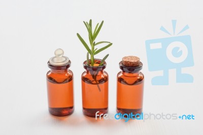 Rosemary Essential Oil With Fresh Leaves Stock Photo