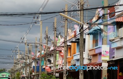 Row Of Colorful Houses With Power Pole And Messy Cable In Thailand Stock Photo