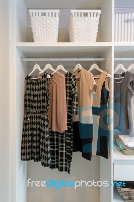 Row Of Dress Hanging In White Wardrobe Stock Photo