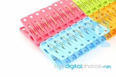 Row Of Peg Package Focus Near Blue On White Background Stock Photo