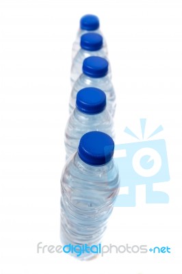 Row Of Plastic Water Bottles Isolated On A White Background Stock Photo