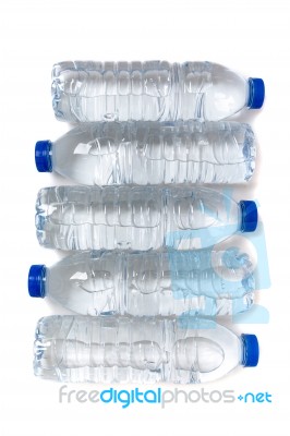 Row Of Plastic Water Bottles Isolated On A White Background Stock Photo