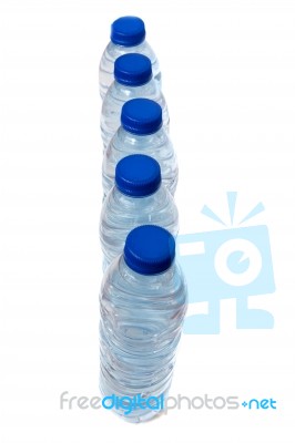 Row Of Plastic Water Bottles Isolated On A White Background Stock Photo