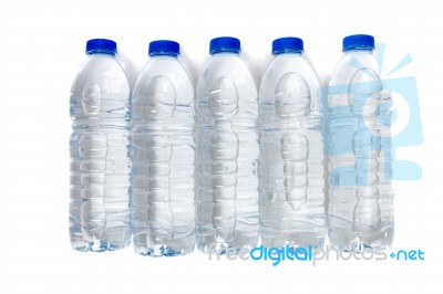 Row Of Plastic Water Bottles Isolated On A White Background Stock Photo