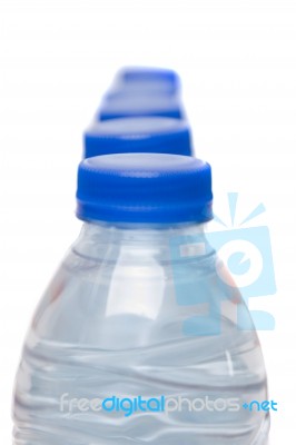 Row Of Plastic Water Bottles Isolated On A White Background Stock Photo