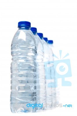 Row Of Plastic Water Bottles Isolated On A White Background Stock Photo