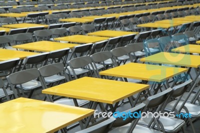 Rows Of Yellow Metal Tables And Chairs Stock Photo