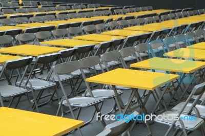 Rows Of Yellow Metal Tables And Chairs Stock Photo