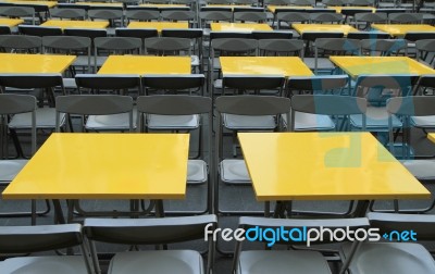 Rows Of Yellow Metal Tables And Chairs Stock Photo