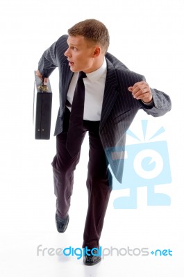 Running Executive Holding Briefcase Stock Photo