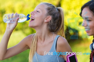 Running Girl Drinking Water After Running Stock Photo