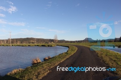 Rural Road Through Water Stock Photo