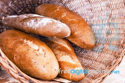 Rye And Wheat Bread Loafs In A Rustic Braided Basket Stock Photo