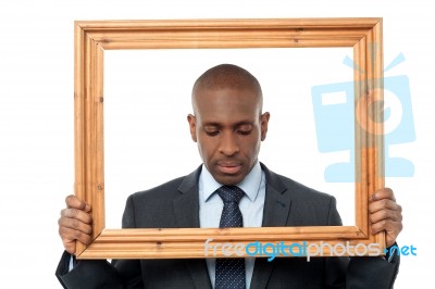 Sad Businessman With Wooden Frame Stock Photo