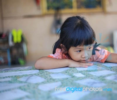 Sad Little Girl Holding Her Face Stock Photo