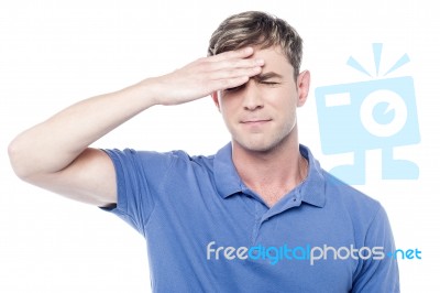 Sad Man Holding His Forehead With His Hand Stock Photo