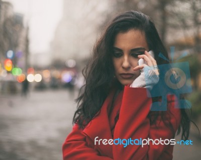 Sad News - Woman In Red Coat Hold On Mobile Phone Stock Photo