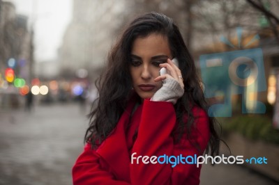 Sad Woman In Red Coat Hold On Mobile Phone, Smartphone, Urban Sc… Stock Photo