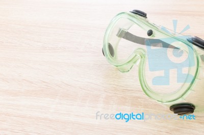 Safety Glasses On Wooden Background Stock Photo