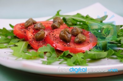 Salad With Fresh Tomatoes, Capers And Arugula Stock Photo