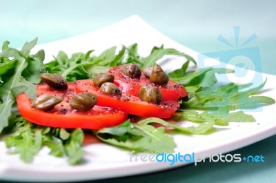 Salad With Fresh Tomatoes, Capers And Arugula Stock Photo