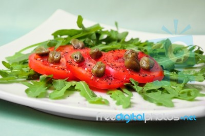 Salad With Fresh Tomatoes, Capers And Arugula Stock Photo