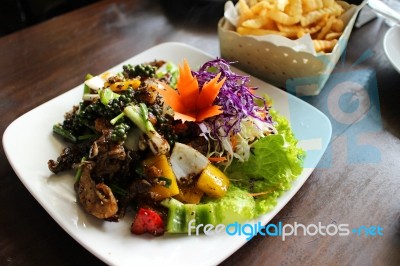 Salad With  Tomatoes, Yellow Bell Pepper On White Plate On Brown Table Background.  Salad For Healthy Food.  Stock Photo