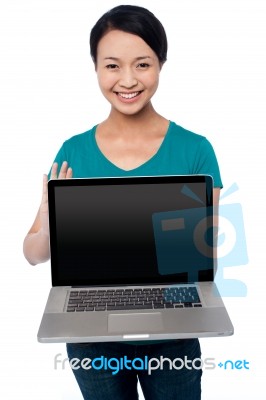 Salesgirl Presenting Brand New Laptop For Sale Stock Photo