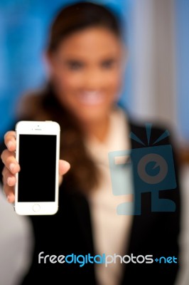 Saleswoman Displaying Newly Launched Mobile Stock Photo