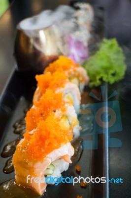 Salmon Sushi Served On Black Plate Stock Photo