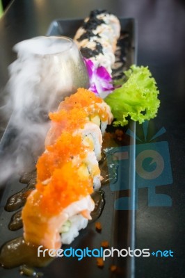 Salmon Sushi Served On Black Plate Stock Photo