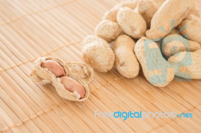 Salted Peanuts On Kitchen Bamboo Mat Stock Photo