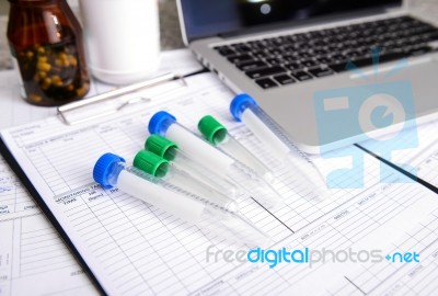 Sample Tube With Labtop Stock Photo