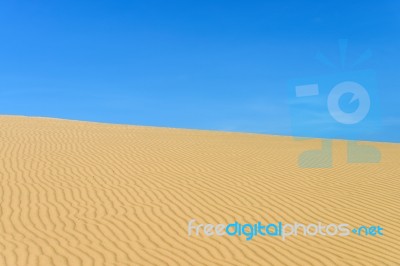 Sand Dune And Blue Sky Stock Photo