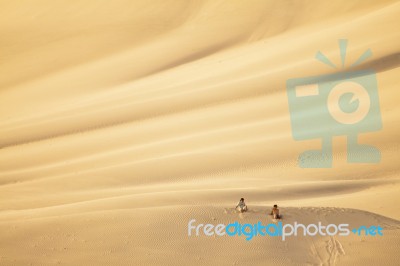 Sand Dune With People Stock Photo